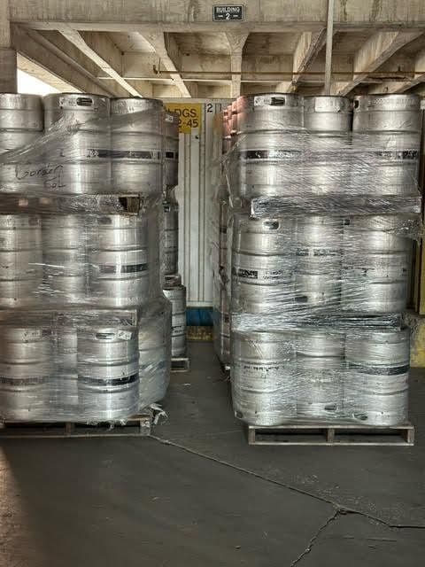 Stacked pallets of kegs in warehouse
